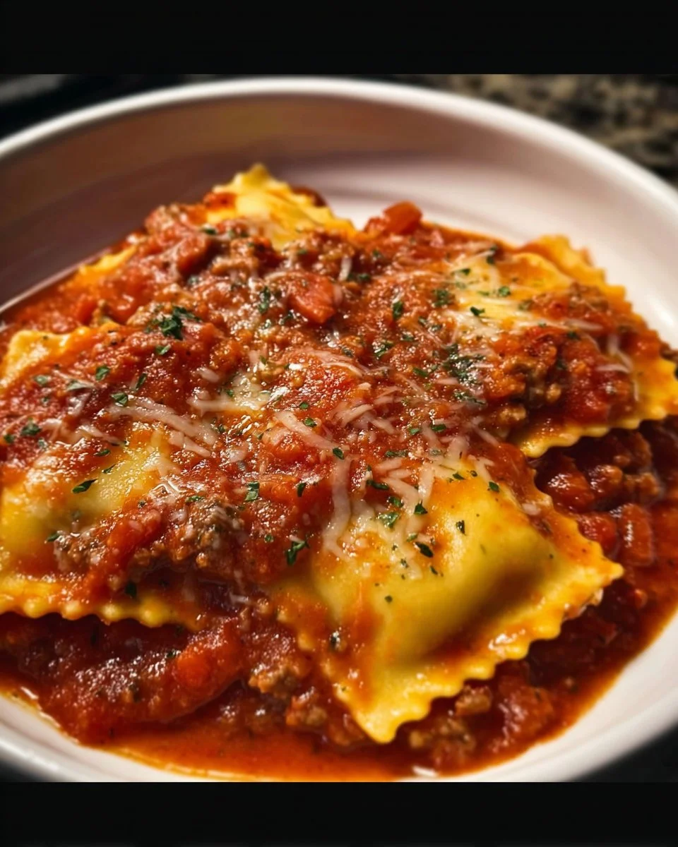 Crockpot ravioli lasagna served in a bowl with melted cheese and fresh herbs