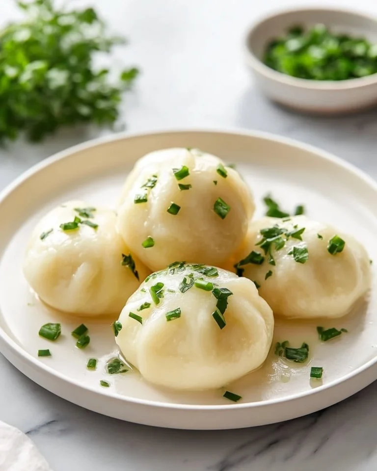 Plate of traditional German potato dumplings garnished with herbs