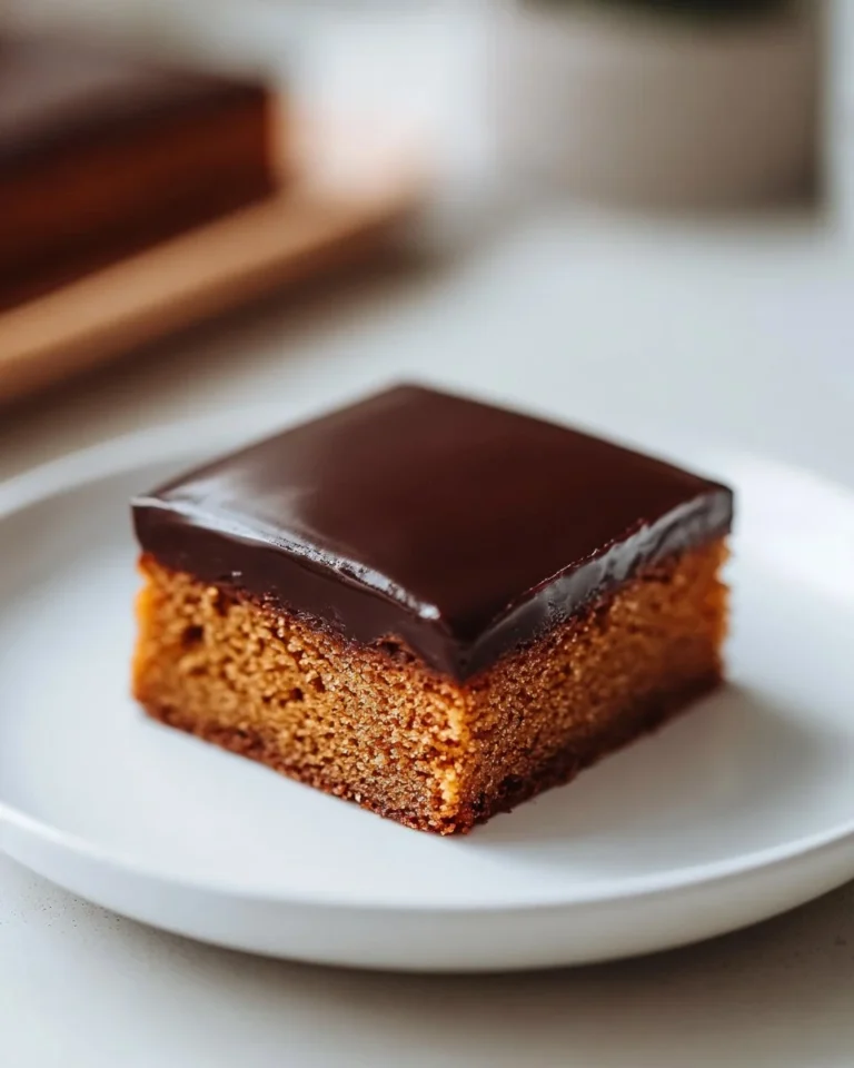 Slice of traditional German honey cake on a plate with honey drizzled on top