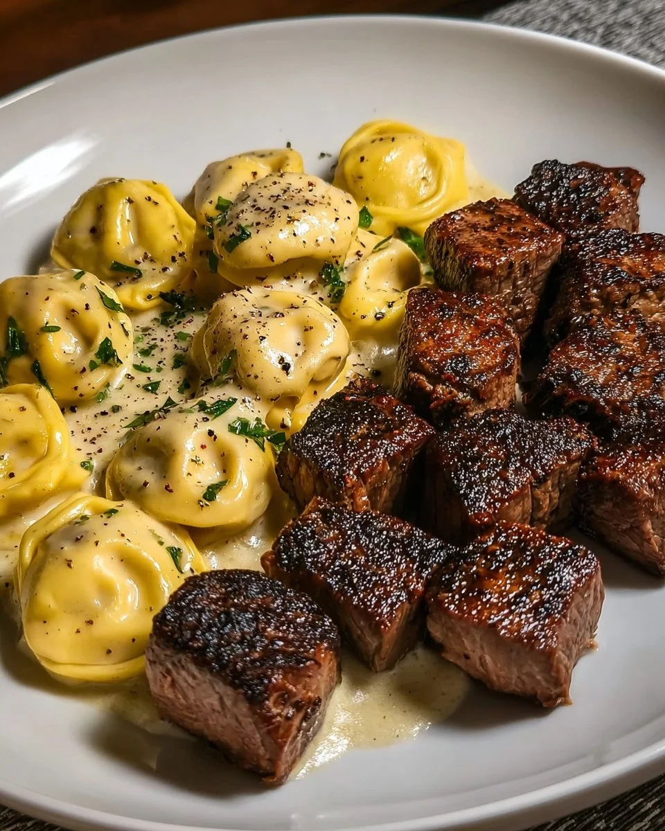 Delicious garlic butter steak bites served with creamy alfredo tortellini.