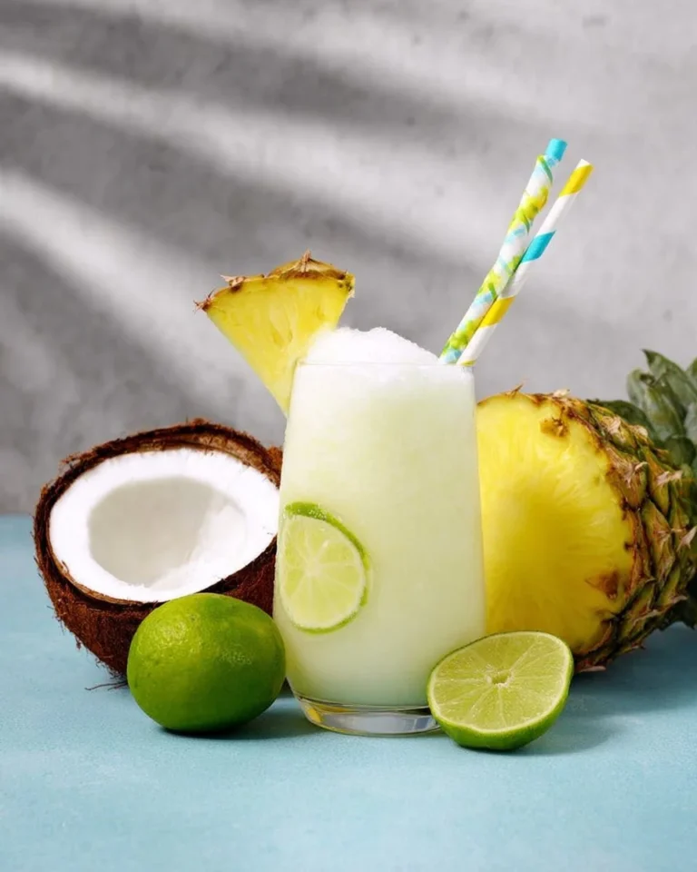 Refreshing Pineapple Spritzer Mocktail served in a glass with garnishes