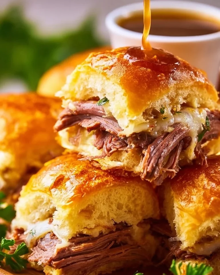 Delicious French Dip Sliders with juicy beef and dipping sauce on a platter