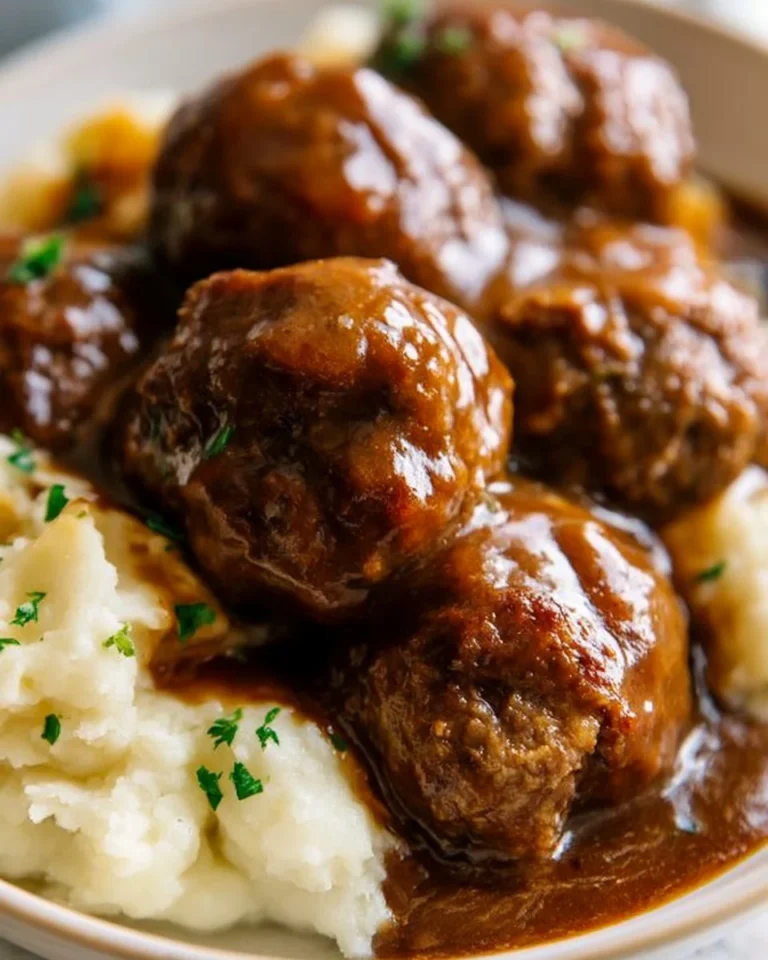 Slow Cooker Salisbury Steak Meatballs served with gravy and mashed potatoes