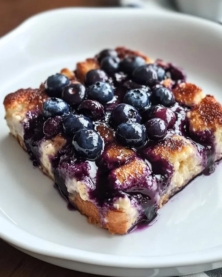 Blueberry French Toast Casserole topped with fresh blueberries and syrup