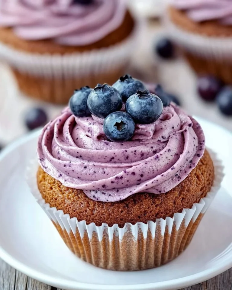 Delicious homemade blueberry frosting spread on a cupcake
