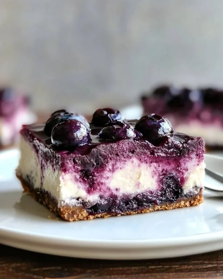 No bake blueberry cheesecake bars topped with fresh blueberries and graham cracker crust