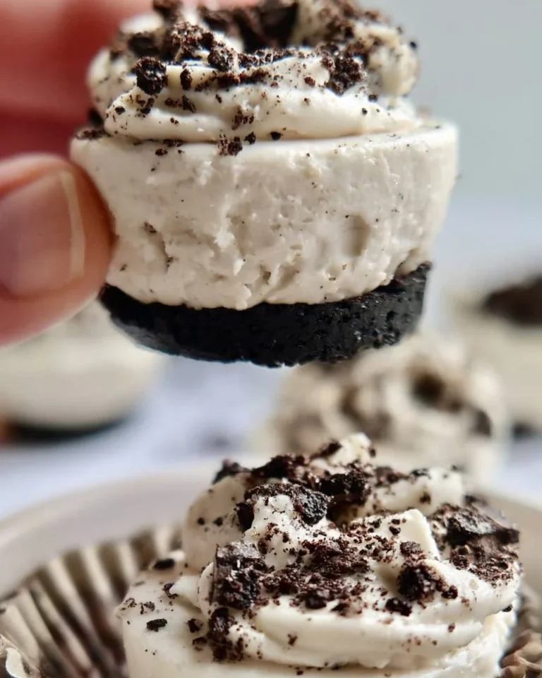 No-bake Oreo cheesecake bites on a plate, garnished with chocolate and Oreos.
