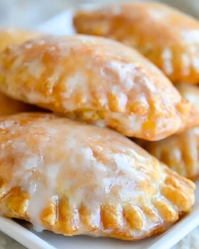 Freshly baked glazed peach hand pies on a plate, summer dessert inspiration