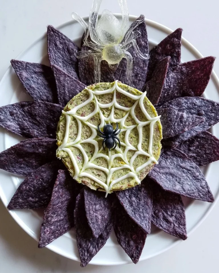 Spiderweb Guacamole served in a unique presentation, featuring creamy avocado and toppings.