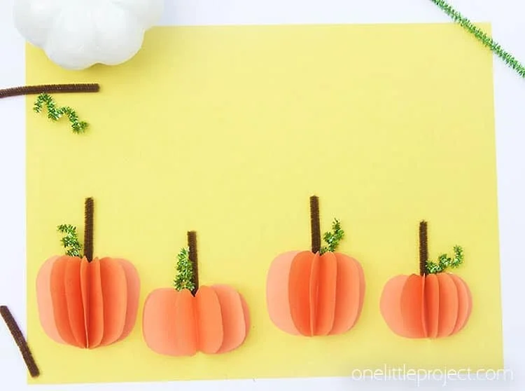 Colorful 3D paper pumpkin craft for Halloween decorations.