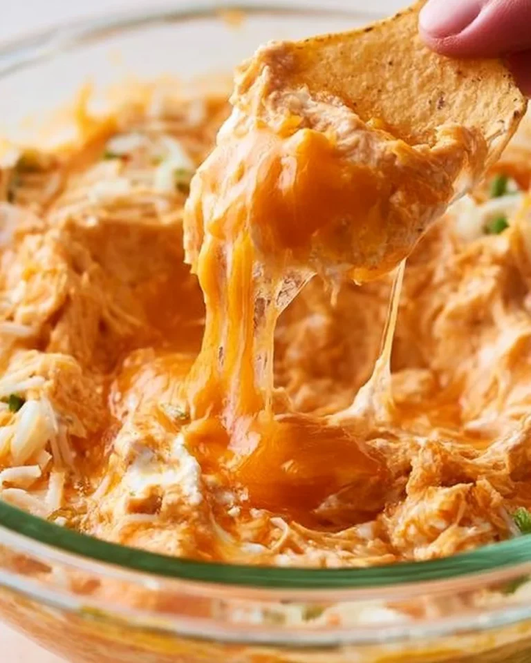 Creamy Buffalo chicken dip served in a bowl with tortilla chips on the side