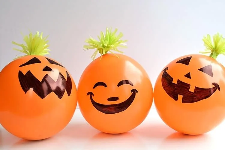 Candy filled balloons shaped like pumpkins for Halloween treats.