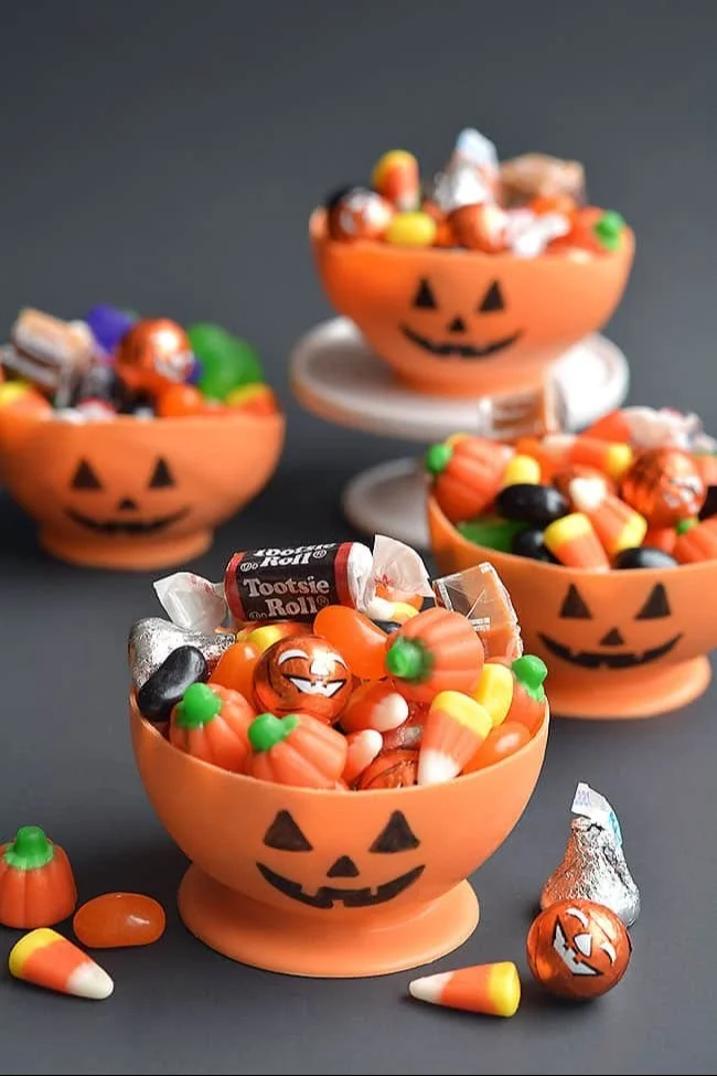 Colorful candy melt pumpkin bowls filled with treats
