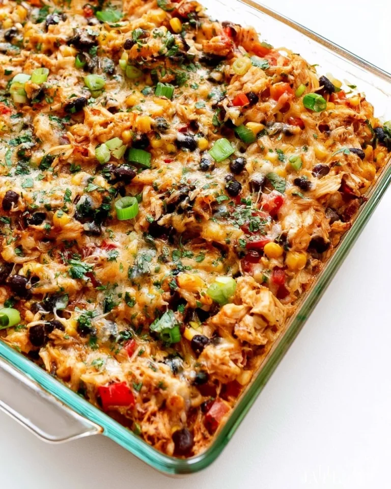 Chicken burrito casserole topped with cheese and fresh ingredients