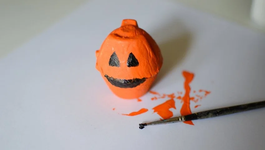 Kids enjoying an easy pumpkin craft activity for Halloween.