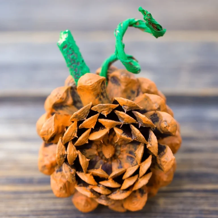 Children making a pine cone pumpkin craft in a fun autumn activity