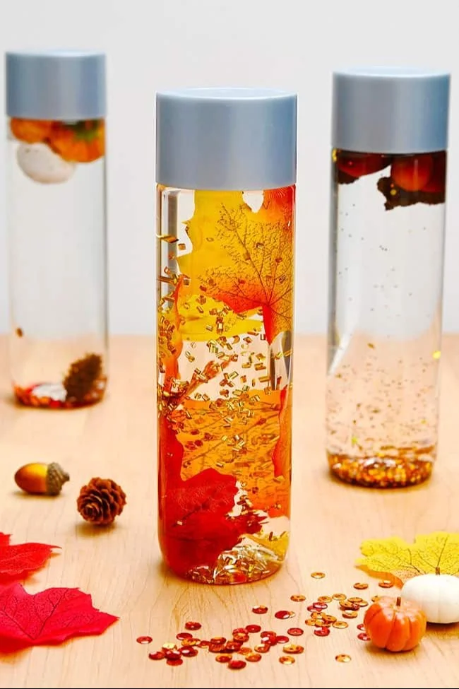 Fall sensory bottles filled with autumn-themed items for sensory play.