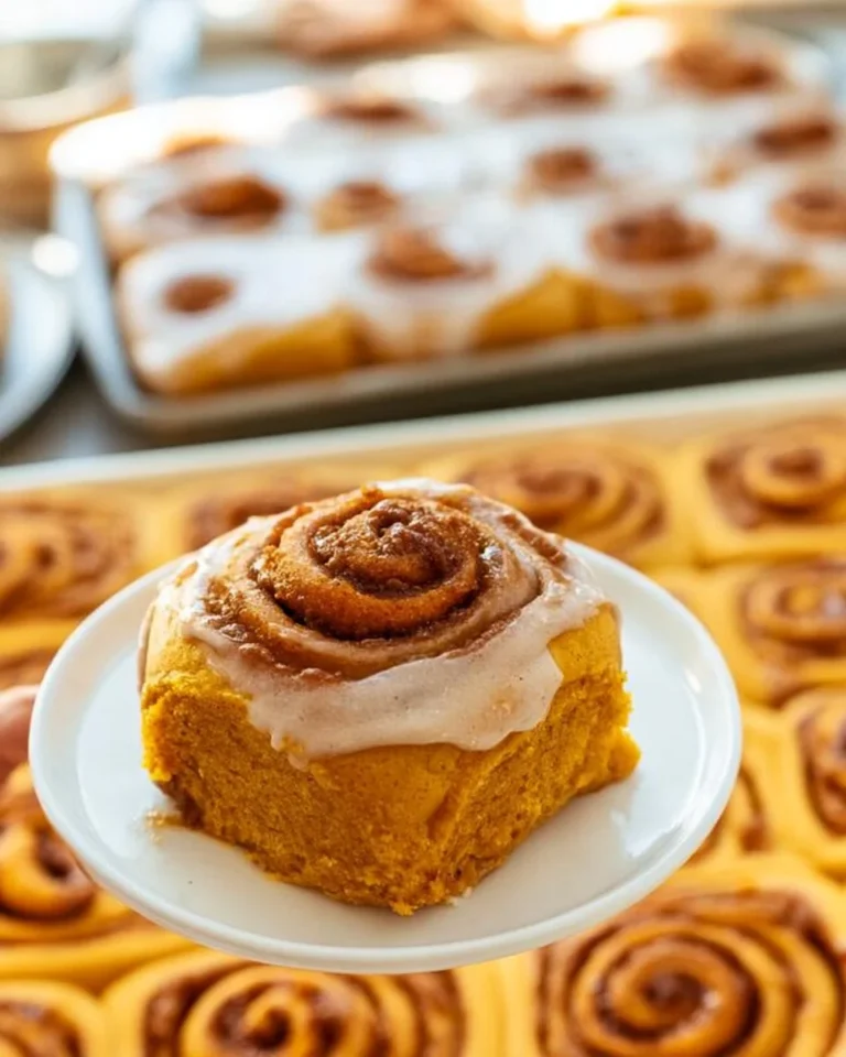 Delicious and fluffy homemade pumpkin cinnamon rolls topped with icing