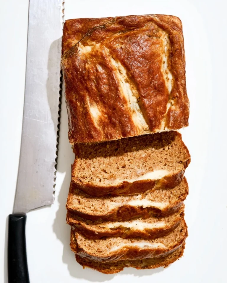 Loaf of Pumpkin Cream Cheese Bread with cream cheese swirls and pumpkin spices