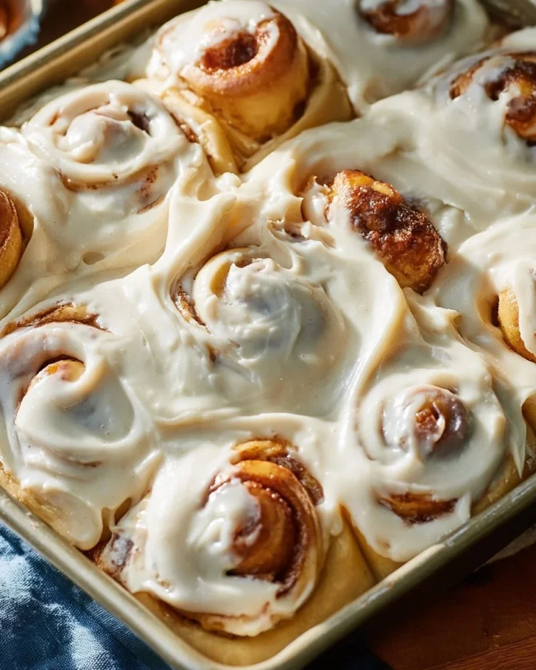 Freshly baked sourdough cinnamon rolls with creamy icing